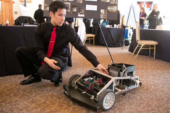 Jared Peterson, a Mechanical Engineering student at UNLV, demonstrates his Autonomous Brass Collecting Rover at the UNLV Fall 2013 Senior Design Competition, Thursday. Dec. 5, 2013.